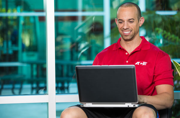 Personal trainer using laptop